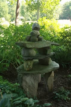 some rocks stacked on top of each other in the grass