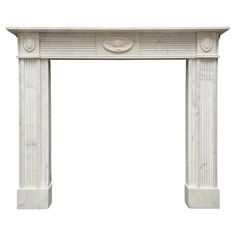 a white marble fireplace mantel with carvings on the front and sides, isolated against a white background