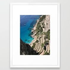 an aerial view of a beach with steps leading to the water and boats in the ocean