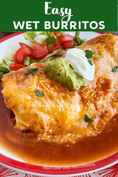 an enchilada on a plate with salsa and sour cream in the background