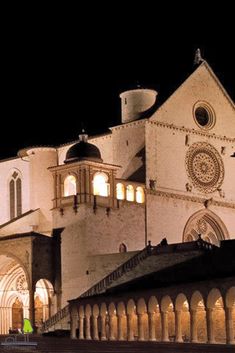 a large white building with arches at night