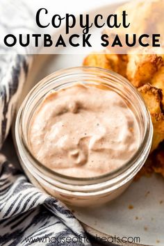 a close up of a plate of food with sauce on it and the words copycat outback sauce