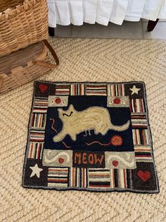 a cat rug is on the floor next to a basket