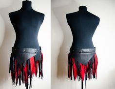 two mannequins with red and black fringes on their backs, one is wearing a leather corset