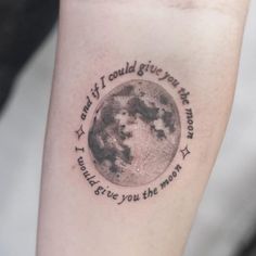 a small tattoo on the leg of a person with a moon and words written below it