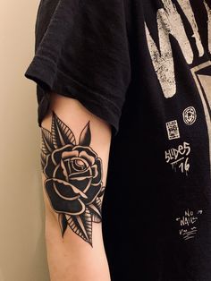 a man with a rose tattoo on his arm