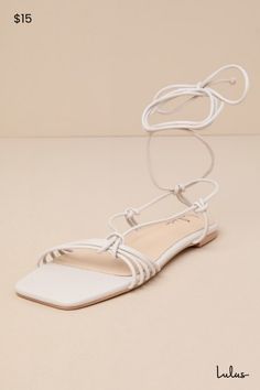 We're obsessed with the casually stunning style of the Lulus Brycin Bone Strappy Lace-Up Sandals! Faux leather shapes a trendy square footbed and a strappy design, formed by a series of knotted ties that flow into a T-strap upper. Matching knotted ties sprout from the sides and lead into long laces that wrap around and tie above the ankle. 0. 25" rubber heel. Cushioned insole. Rubber sole has nonskid markings. Man made materials. Imported. Lulus | Brycin Bone Strappy Lace-Up Sandal Heels. Summer Strappy Lace-up Sandals With 4-inch Heel, Affordable Adjustable Strappy Lace-up Sandals, Casual Synthetic Lace-up Strappy Sandals, Chic Strappy Synthetic Lace-up Sandals, White Leather Strappy Lace-up Sandals, Lace Up Sandal Heels, Casual Wedding Dress, White Sandals, Lulu Fashion