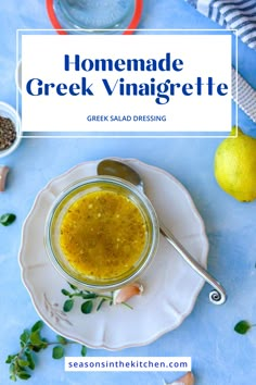 homemade greek vinaigrete in a glass jar on a plate with lemons and herbs