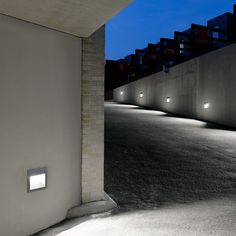 an empty parking lot at night with lights on