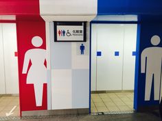 two men and a woman are standing in the restroom