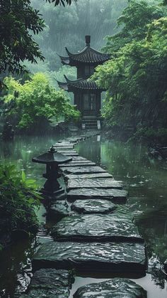 a long stone path that leads to a pagoda in the rain