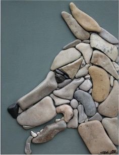 an image of a dog made out of rocks on the ground with text that reads pinterest com