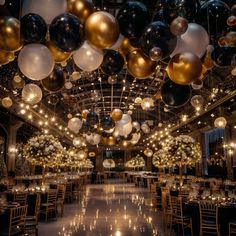 a room filled with lots of balloons and tables covered in gold, black and white decorations