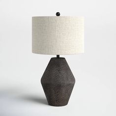 a black table lamp with a white shade on it