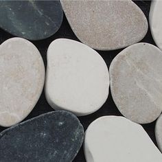 several white and black rocks sitting next to each other