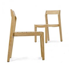 two wooden chairs sitting next to each other