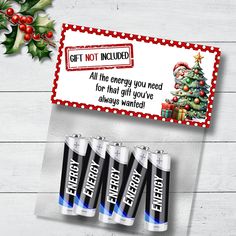 four aa batteries next to a christmas card