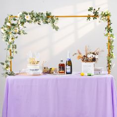 the table is covered with flowers and bottles