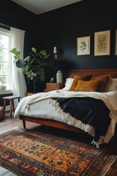 a bedroom with black walls and white bedding has a rug on the floor next to it