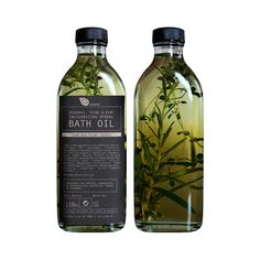 two bottles of bath oil sitting next to each other