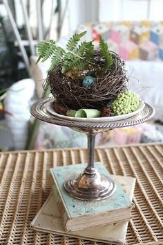 a bird's nest sitting on top of a cake plate