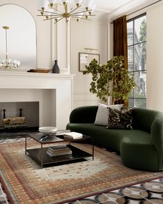 a living room filled with furniture and a fire place next to a large mirror on the wall