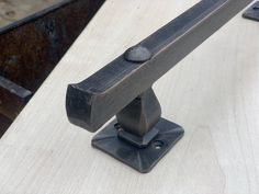 a close up of a metal handle on a wooden table