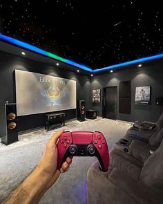 a person holding a video game controller in front of a projection screen