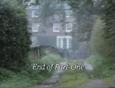 the end of part one is in front of an old house with trees and bushes