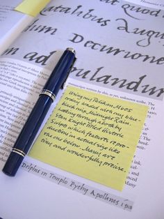 a pen sitting on top of an open book