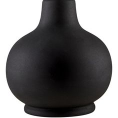 a black vase sitting on top of a white table