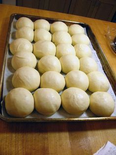 a pan filled with dough sitting on top of a wooden table