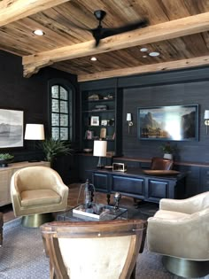 a living room filled with lots of furniture and wooden ceilings covered in wood planks