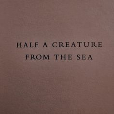 the words on the wall are written in black and white ink, which reads half a creature from the sea