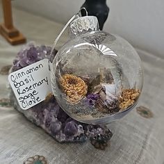 a glass ornament filled with flowers on top of a table