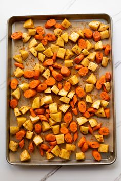 roasted potatoes and carrots on a baking sheet