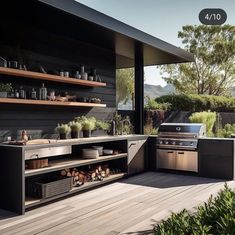 an outdoor kitchen with stainless steel appliances and open shelving on the outside deck area