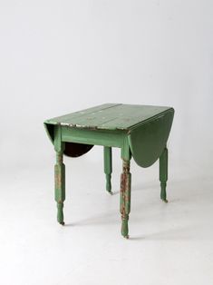 an old green table with a hole in the top