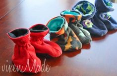 five pairs of slippers sitting on top of a wooden table