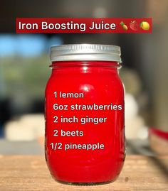 a red mason jar with instructions on how to use lemons and strawberries for juice