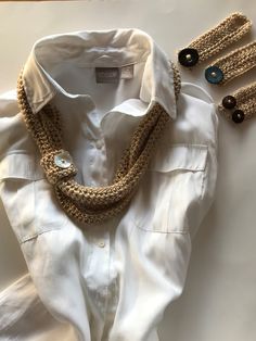 This golden scarf is a modern twist on the infinity scarf. It consists of one long loop and 4 button wraps which add a lot of different wearing options. The long loop can be wrapped three, four or possibly five times for different lengths. The length is about 15 inches when the scarf has been wrapped three times (shown in the picture with the white blouse).  The blouse is not included in this offer.  I got the idea to make this scarf when I saw the triple skinny scarf on www.littlemonkeyscrochet Scarf Curls, Golden Scarf, Coconut Wood, The Infinity, White Blouse, Infinity Scarf, Acrylic Yarn, I Saw, Scarf Wrap