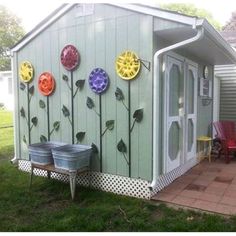 a small shed with flowers painted on the side