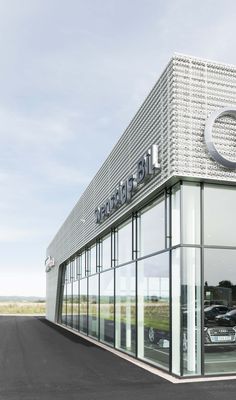 a car dealership with cars parked in front