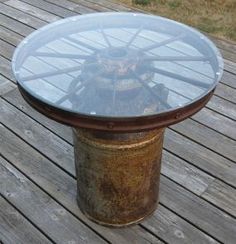 a round glass table sitting on top of a wooden deck