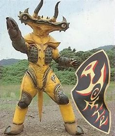 a man in yellow and black costume standing next to a sign with horns on it