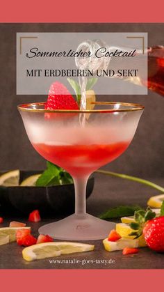 a cocktail is garnished with strawberries and lemons