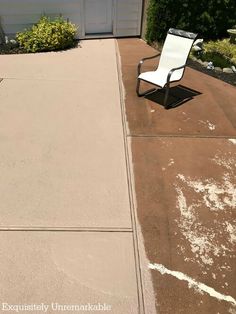 an empty lawn chair sitting in front of a garage