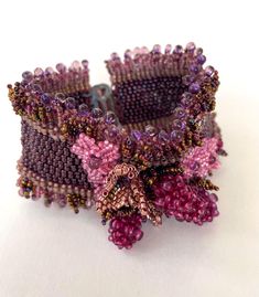 A beautifully detailed hand crafted cuff bracelet adorned with bramble berries in lovely jewelled tones. Part of a three piece set comprising of a cuff bracelet, a brooch and lariat necklace, but can be purchased separately. Elegant Beaded Cuff Bracelet As Gift, Elegant Beaded Cuff Jewelry, Elegant Beaded Cuff Bracelet For Gift, Elegant Beaded Cuff Bracelets, Unique Beaded Bracelets For Wedding, Beaded Jewelry For Crafting - Wearable Art, Bohemian Beaded Cuff Jewelry, Beaded Cuff Jewelry Gift, Elegant Beaded Bracelets With Unique Variations Gift