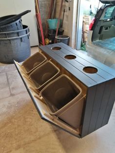 the inside of a garage with several bins in it