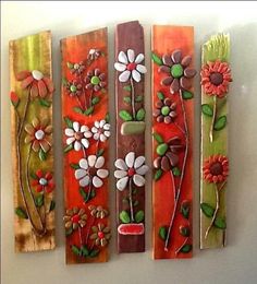 four wooden wall hangings with flowers painted on them